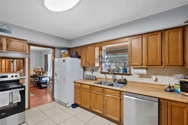 a kitchen with a refrigerator and a sink