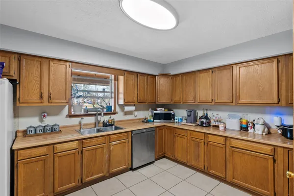a kitchen with a sink window and cabinets