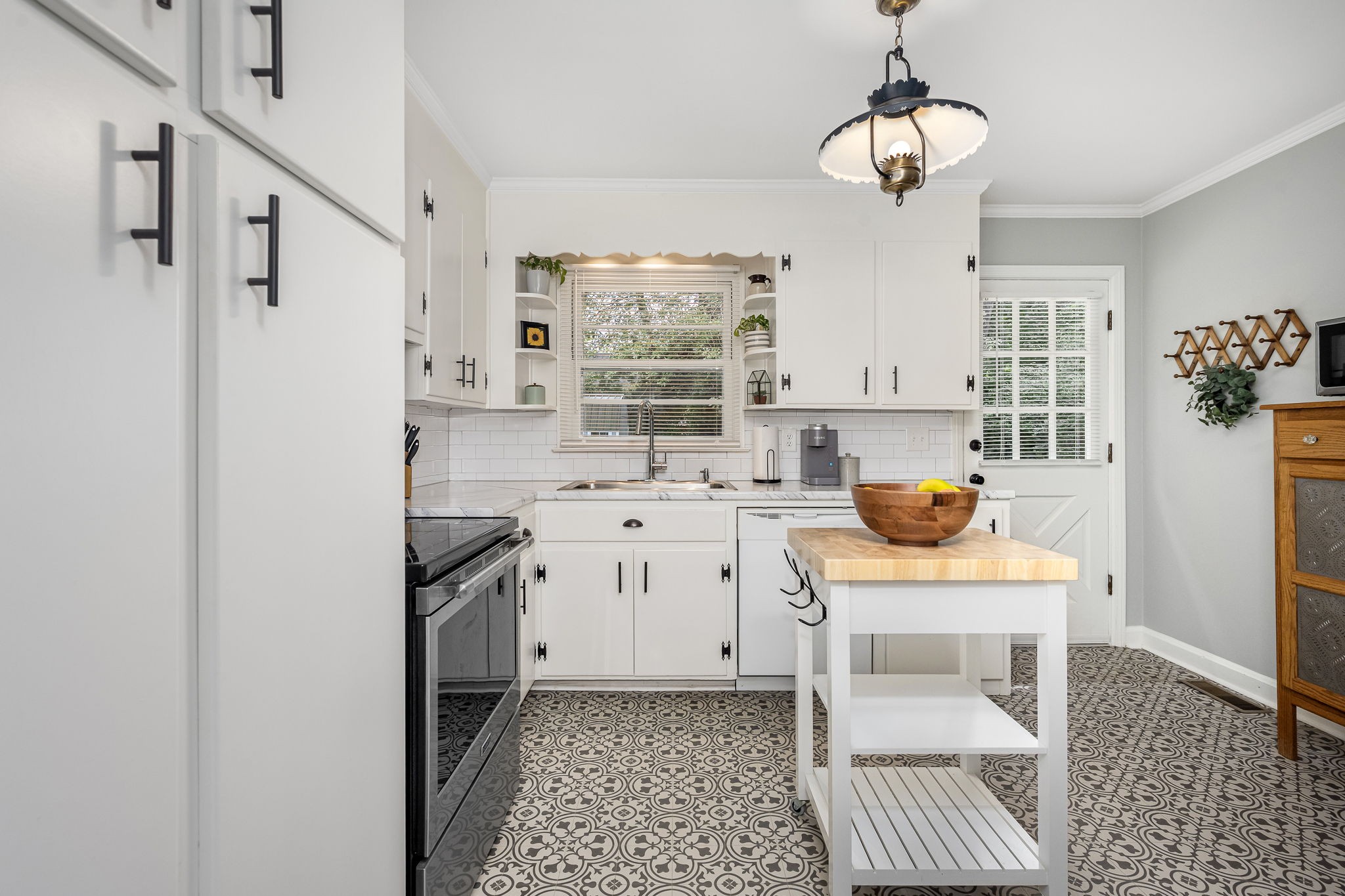 607 Staley Street Murfreesboro, TN 37129 - Photo 8 of 31 a kitchen with stainless steel appliances a sink a stove a dining table and chairs