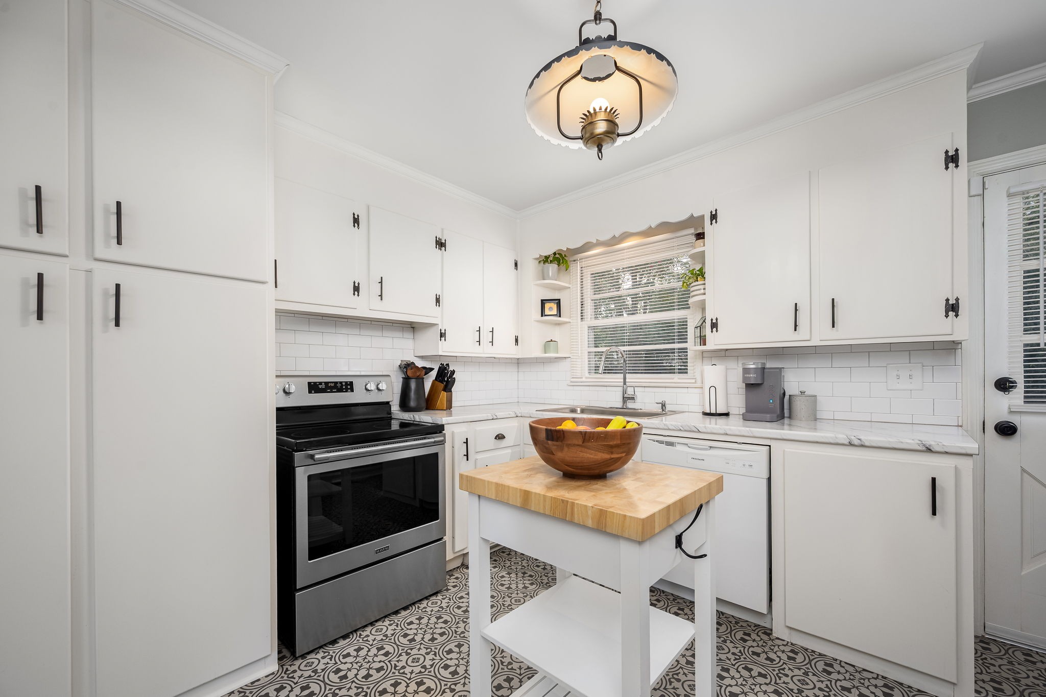 607 Staley Street Murfreesboro, TN 37129 - Photo 9 of 31 a kitchen with a stove a sink and cabinets