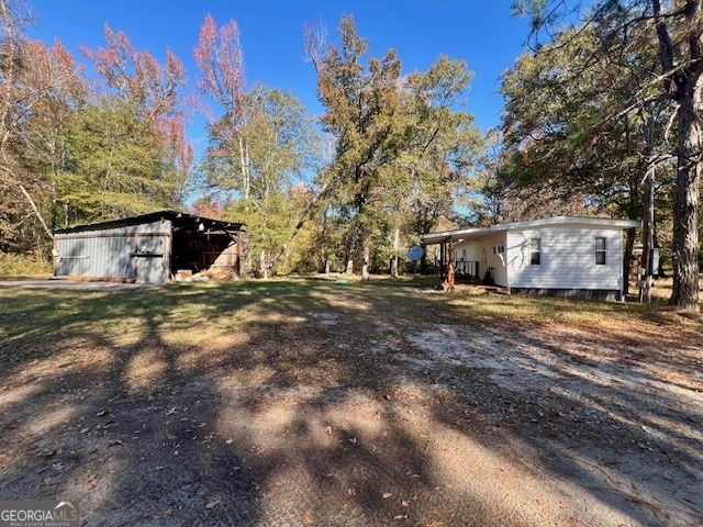 3195 Henderson Grove Road Sandersville, GA 31082 - Photo 16 of 50 a view of a house with a yard