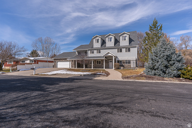 View of front of home with covered porch and driveway