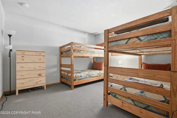 a bedroom with a bunk bed and a dresser