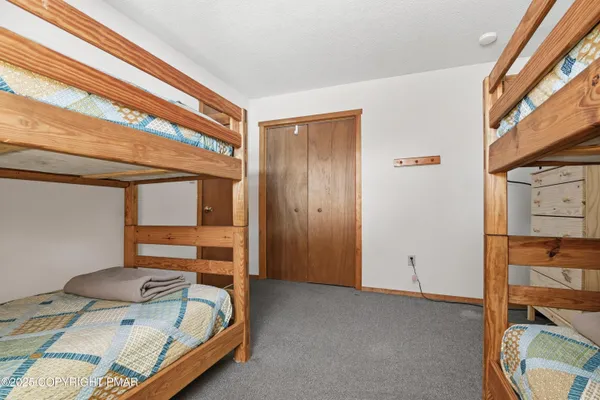 a bed room with a bed and a book shelf