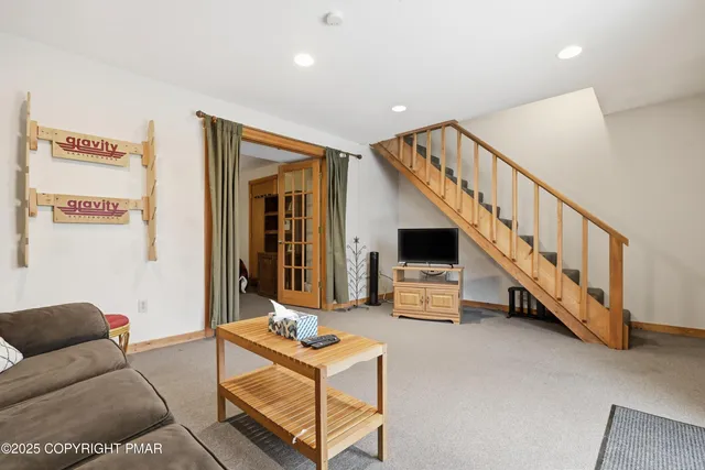 a living room with furniture and stairs