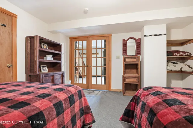 a bedroom with a bed and a large window