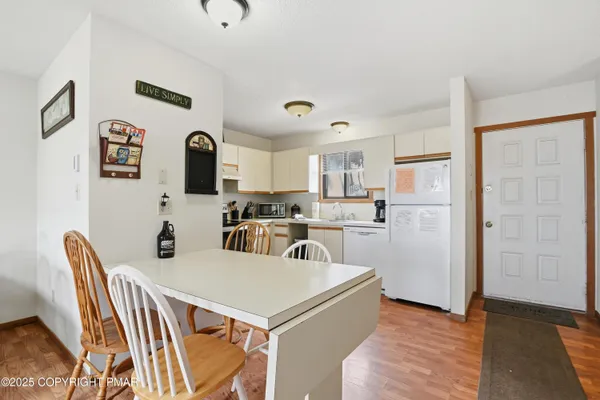 a view of kitchen with cabinets and wooden floor