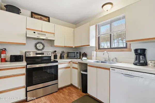 a kitchen with a sink stove and cabinets