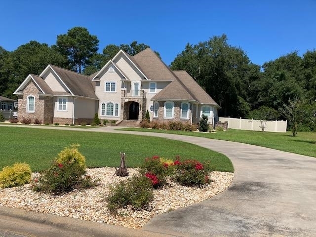 a front view of a house with a garden