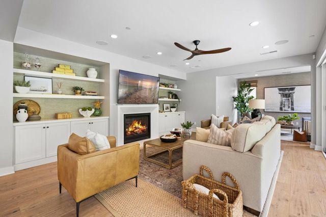 a living room with furniture fireplace and a window
