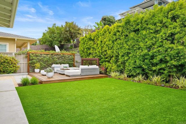 a view of a chair and table in the garden