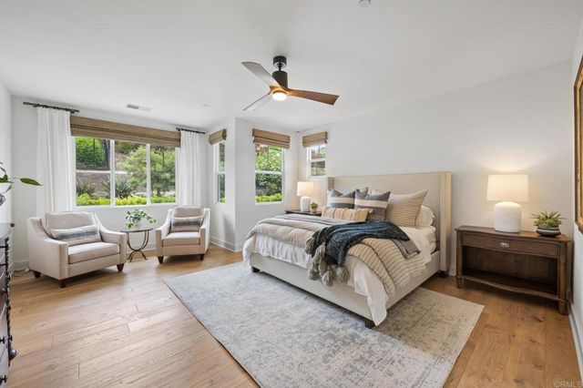 a bedroom with a large bed and a large window