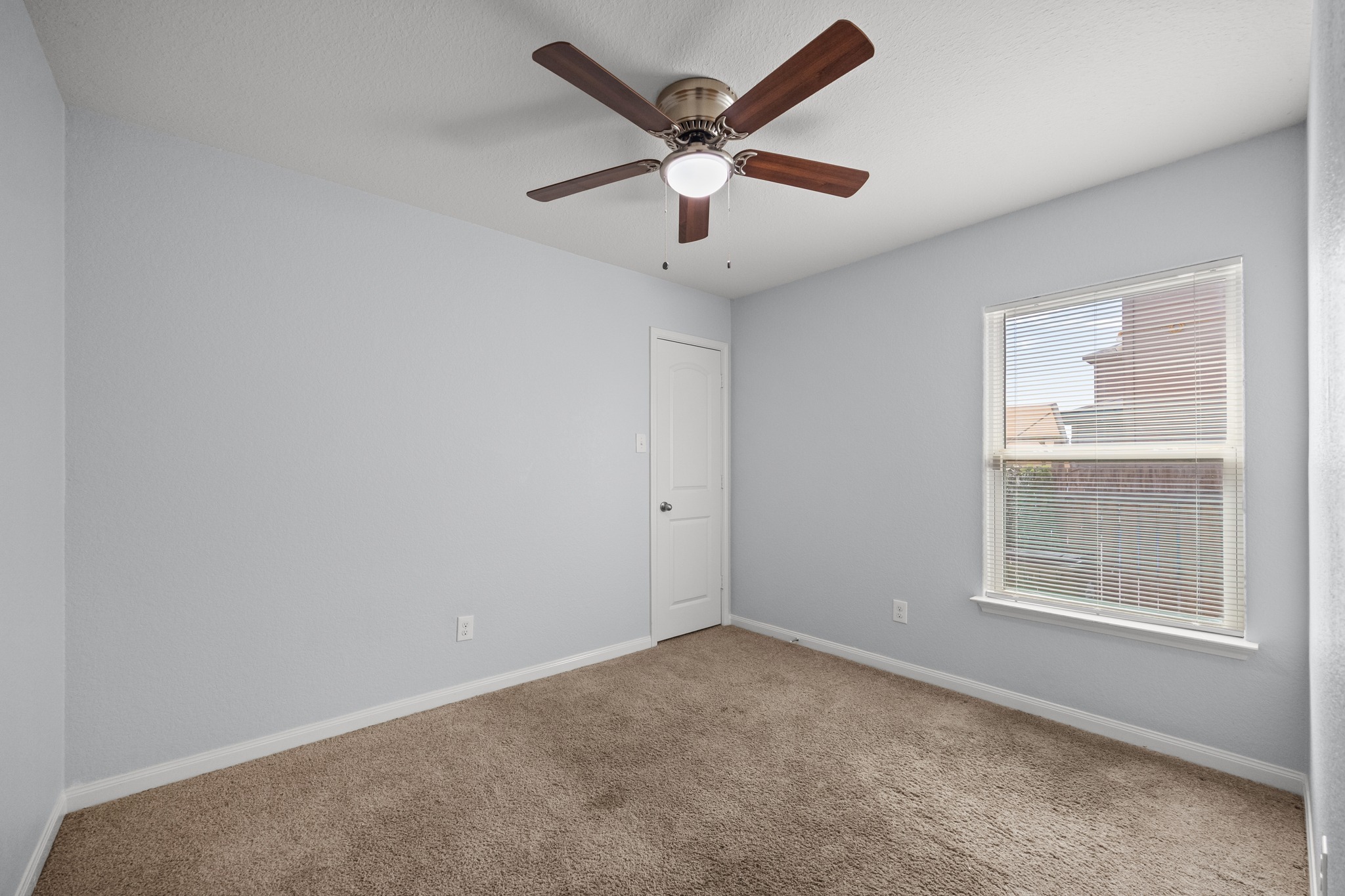 228 Millers Loop Jarrell, TX 76537 - Photo 12 of 26 Soft carpeting pairs with neutral walls and classic white trim in this secondary bedroom.