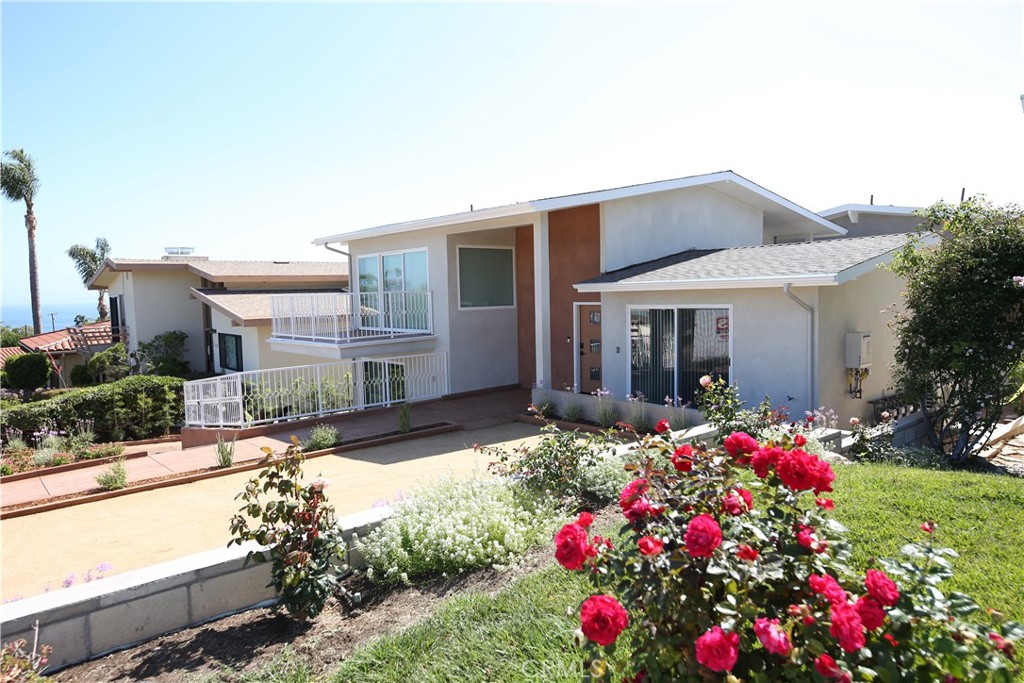 5 Clipper Road, Unit A Rancho Palos Verdes, CA 90275 - Photo 20 of 20 a front view of house and yard with beautiful flowers and green space