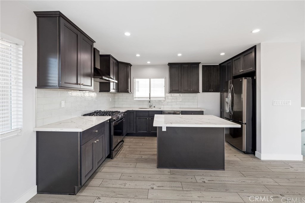 5 Clipper Road, Unit A Rancho Palos Verdes, CA 90275 - Photo 6 of 20 a kitchen with stainless steel appliances granite countertop a stove top oven a refrigerator and a sink