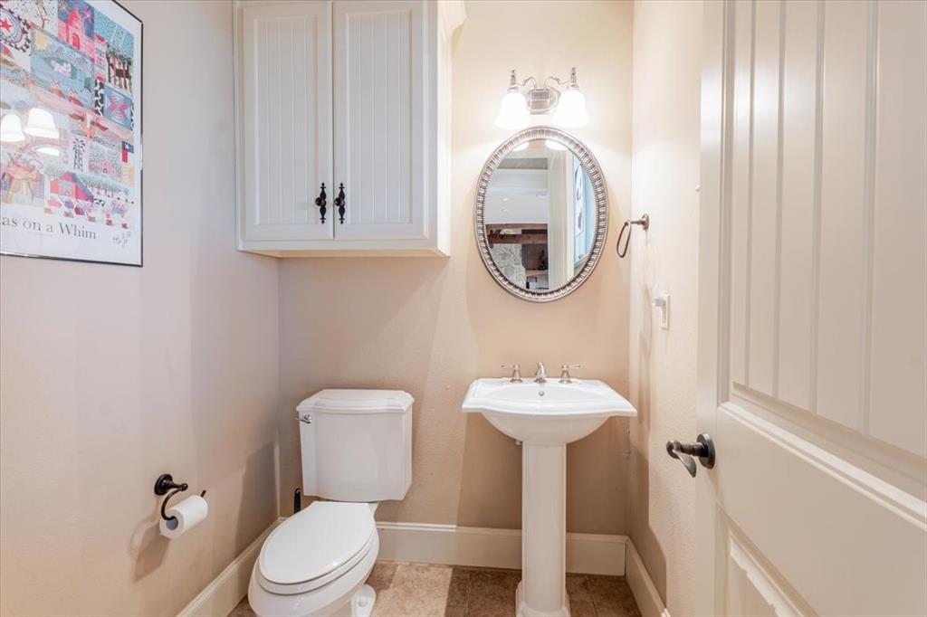 11918 Riek Road Krum, TX 76249 - Photo 29 of 40 a bathroom with a toilet sink and mirror