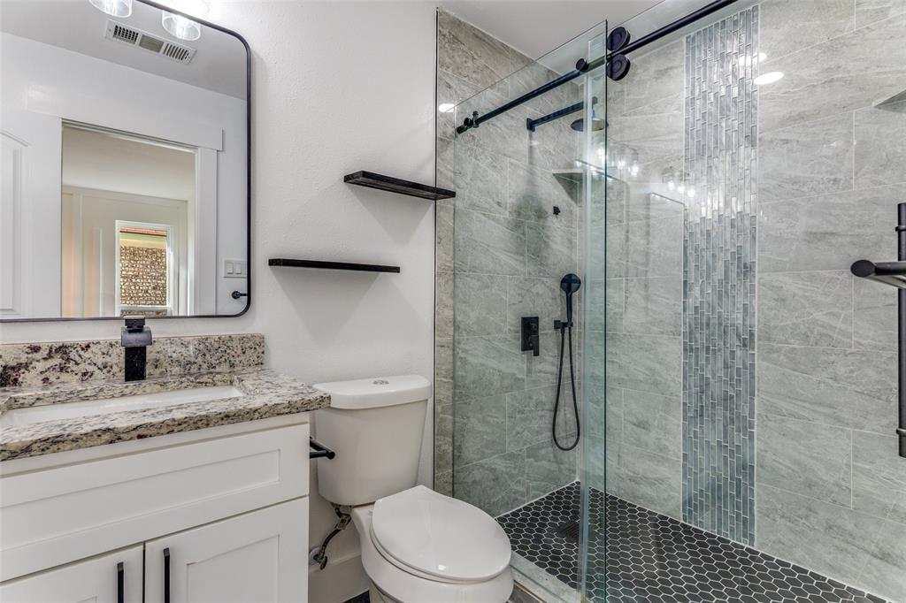 6617 Starnes Road Watauga, TX 76148 - Photo 13 of 22 a bathroom with a shower sink vanity mirror and toilet