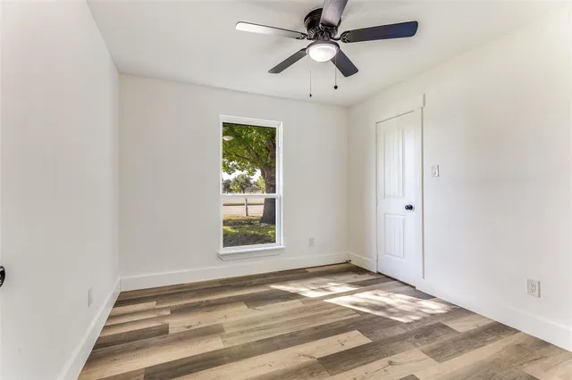 a bathroom with a granite countertop sink a toilet and a mirror