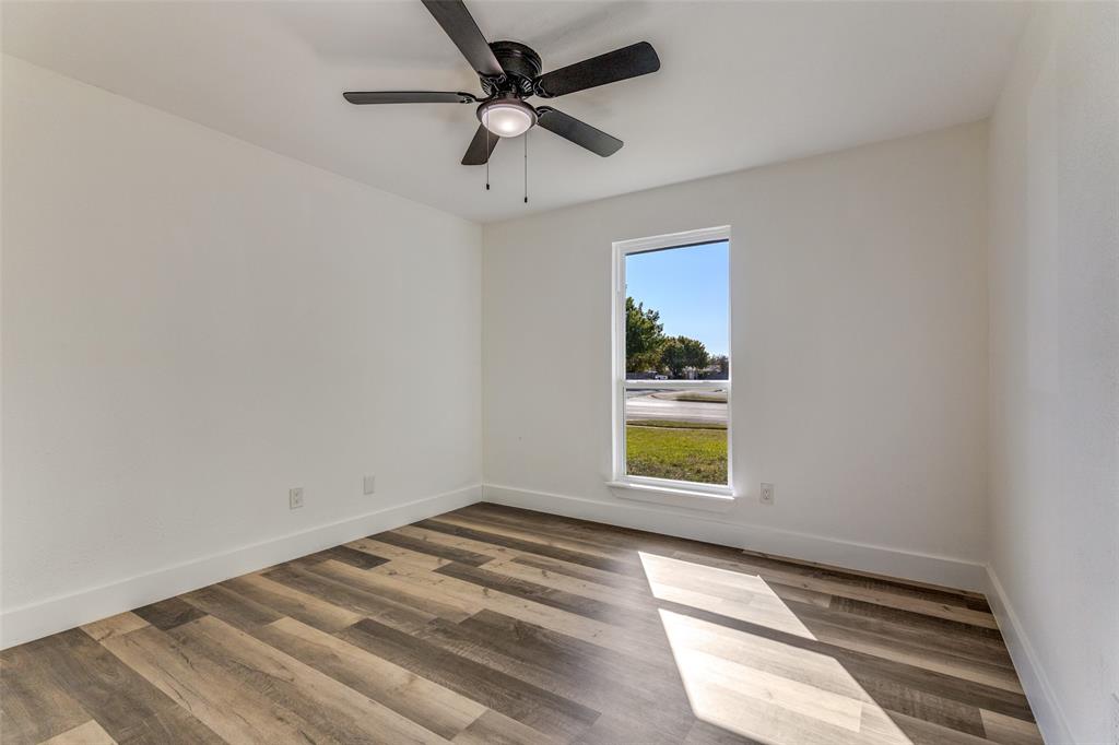 6617 Starnes Road Watauga, TX 76148 - Photo 17 of 22 an empty room with a window and a ceiling fan
