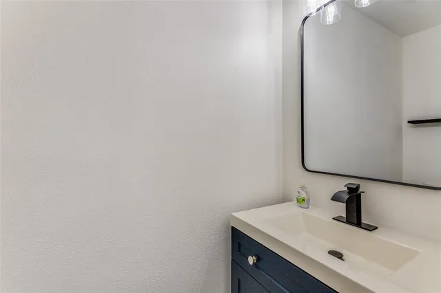 an empty room with a window and a ceiling fan