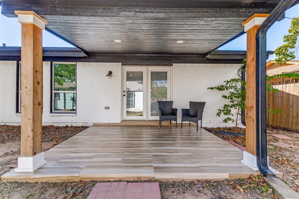6617 Starnes Road Watauga, TX 76148 - Photo 19 of 22 a view of a patio with table and chairs and wooden floor
