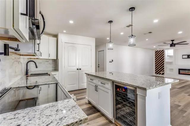a kitchen with kitchen island a stove a counter top space and wooden floor
