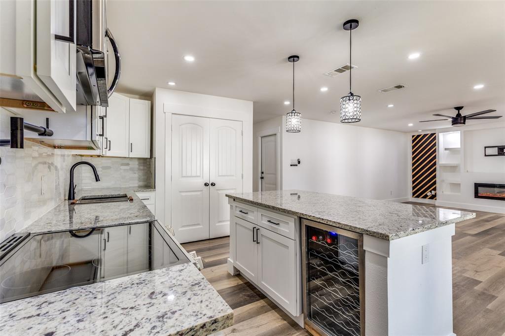 6617 Starnes Road Watauga, TX 76148 - Photo 6 of 22 a kitchen with stainless steel appliances granite countertop a sink a stove a refrigerator and white cabinets