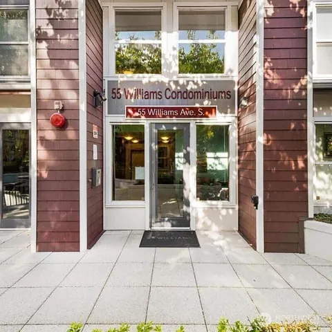 a view of a brick building with a large window and door
