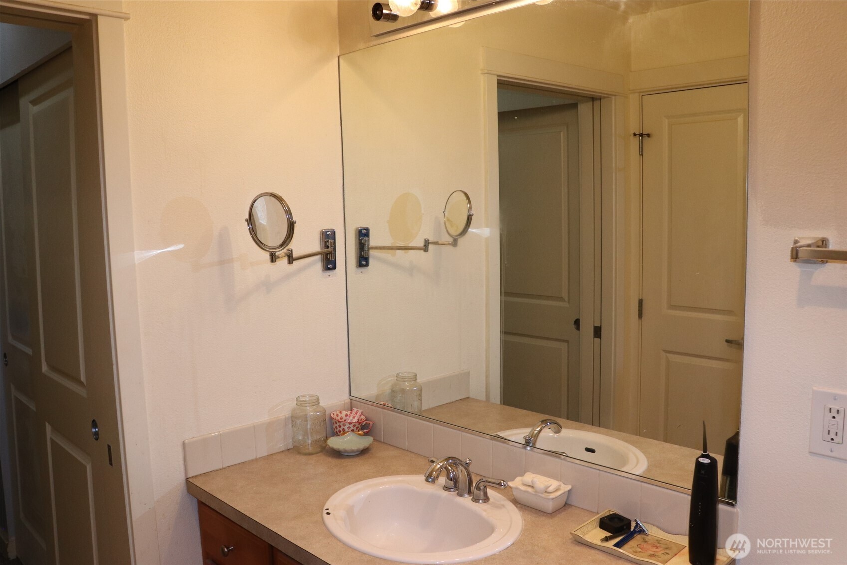 55 Williams Avenue South, Unit 104 Renton, WA 98057 - Photo 18 of 22 a bathroom with a sink a mirror and shower