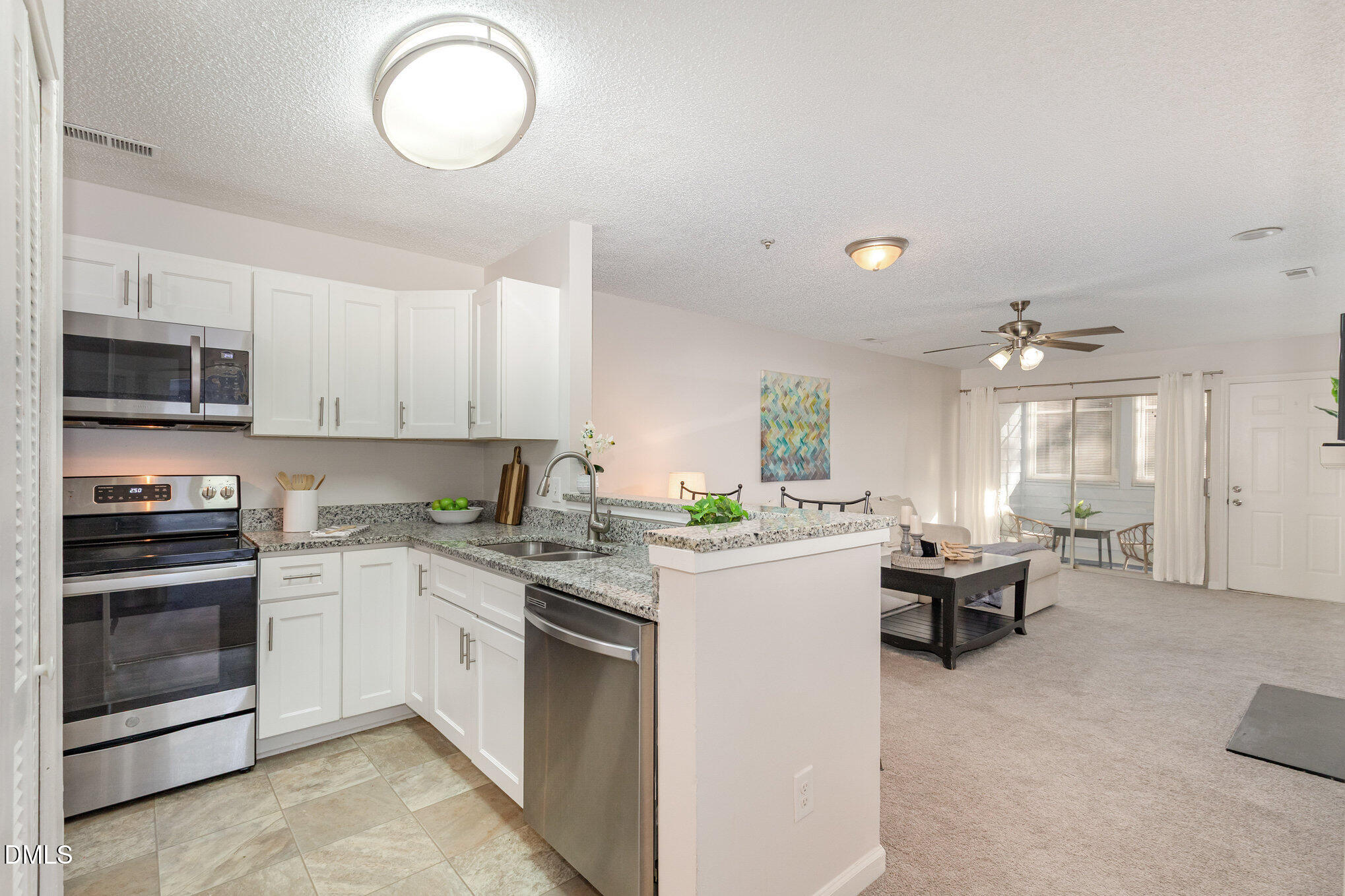 4911 Hollenden Drive, Unit 108 Raleigh, NC 27616 - Photo 8 of 19 a kitchen that has a sink and a stove in it