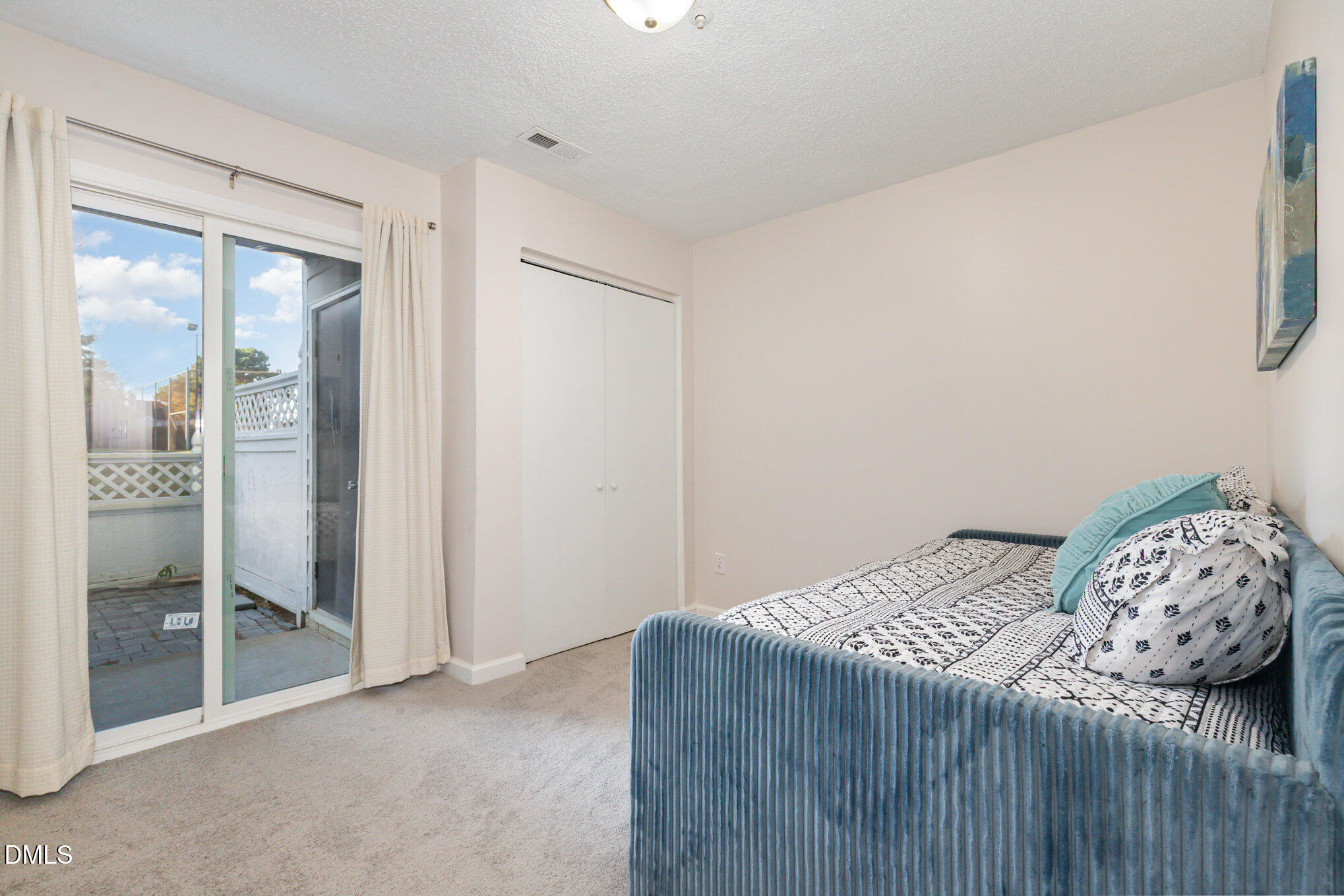 4911 Hollenden Drive, Unit 108 Raleigh, NC 27616 - Photo 12 of 19 a bedroom with a bed and a window