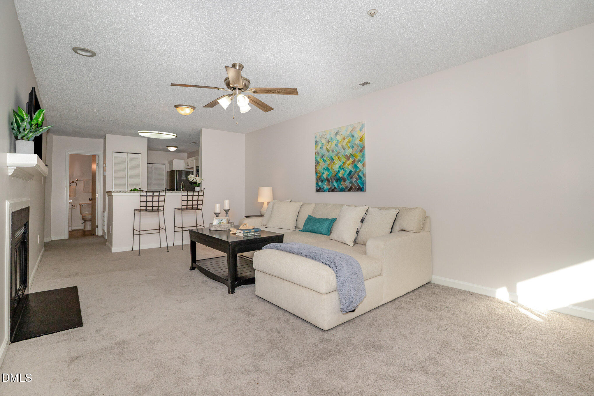 4911 Hollenden Drive, Unit 108 Raleigh, NC 27616 - Photo 3 of 19 a living room with furniture and a chandelier