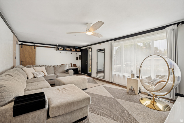 1215 8th Street Ogden, UT 84404 - Photo 6 of 39 Spacious living area featuring expansive windows, wood-finish flooring, and a ceiling fan with integrated lighting