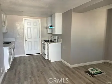 a kitchen with a wooden floor and a stove