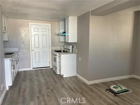 a kitchen with a wooden floor and a stove