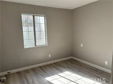 595 North Fillmore Place, Unit B1 Pomona, CA 91768 - Photo 2 of 4 an empty room with a window