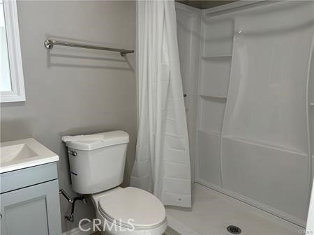 595 North Fillmore Place, Unit B1 Pomona, CA 91768 - Photo 3 of 4 a white toilet sitting next to a shower