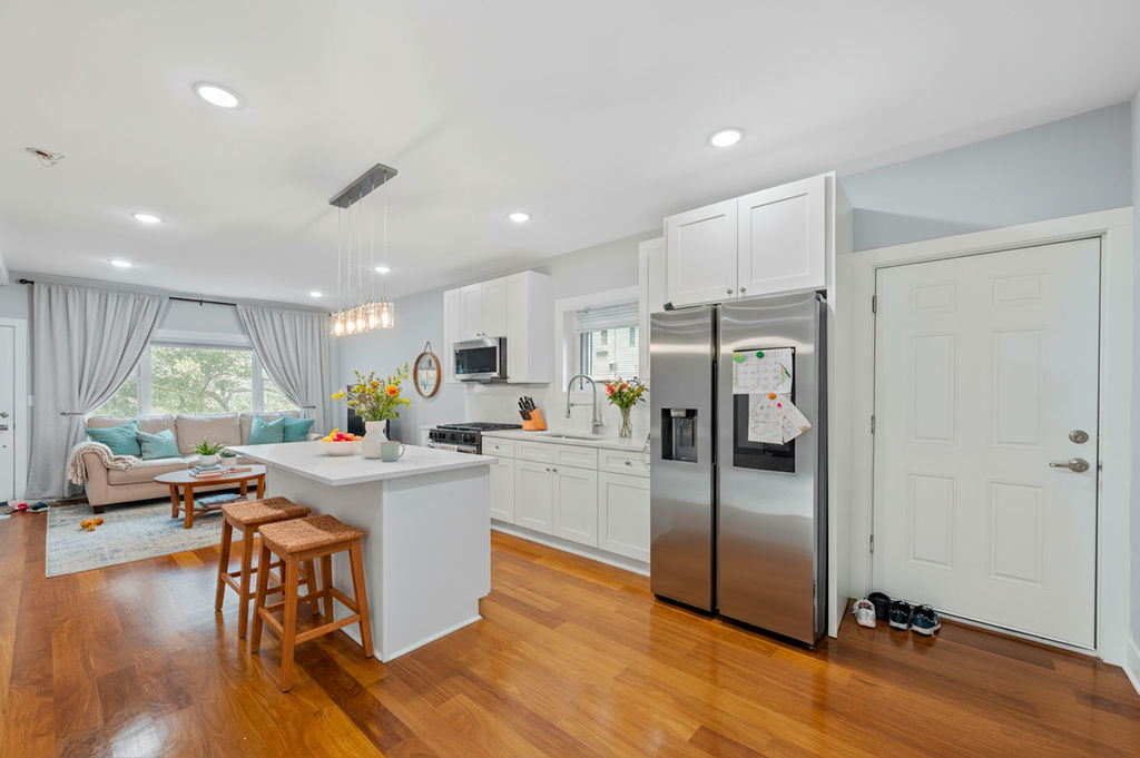 13518 South Ave K Chicago, IL 60633 - Photo 12 of 24 a kitchen with a dining table chairs refrigerator and cabinets