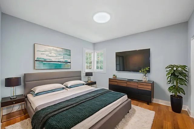 a bedroom with a bed and a flat screen tv