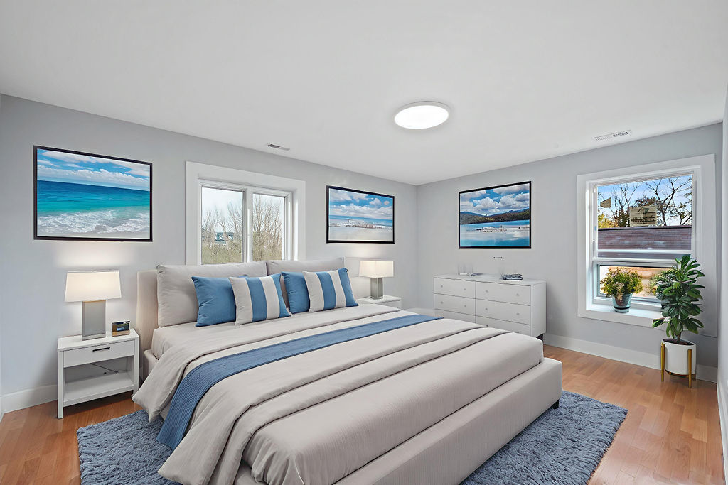 13518 South Ave K Chicago, IL 60633 - Photo 16 of 24 a bedroom with a balcony a large bed and a painting on the wall