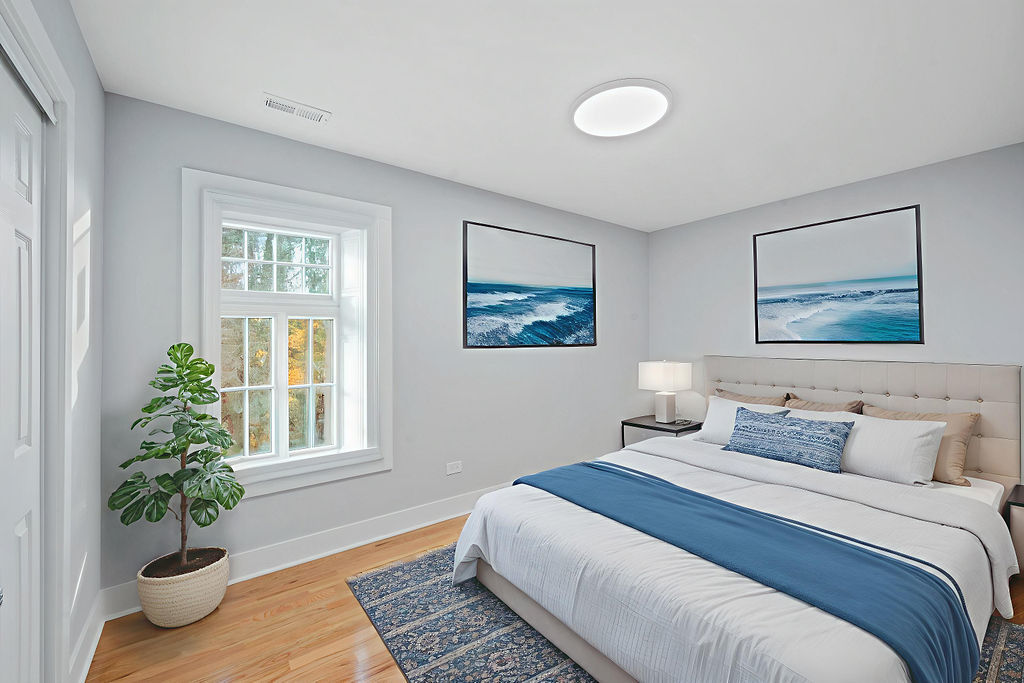 13518 South Ave K Chicago, IL 60633 - Photo 18 of 24 a bedroom with a large bed and a potted plant