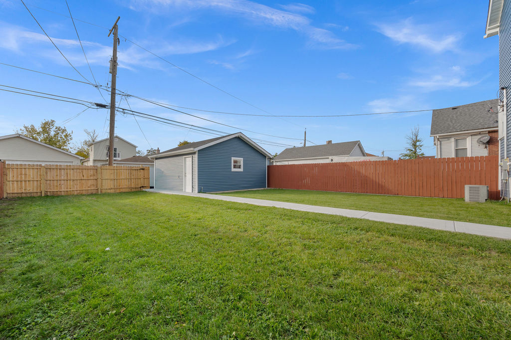 13518 South Ave K Chicago, IL 60633 - Photo 24 of 24 a front view of a house with garden