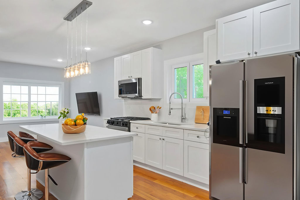 13518 South Ave K Chicago, IL 60633 - Photo 9 of 24 a kitchen with a refrigerator a sink a stove and white cabinets with wooden floor