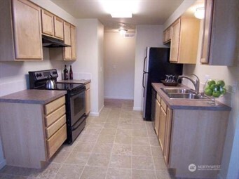 1928 J Street, Unit 205 Walla Walla, WA 99362 - Photo 2 of 20 a kitchen with stainless steel appliances granite countertop a stove a sink and a refrigerator