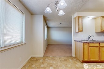 1928 J Street, Unit 205 Walla Walla, WA 99362 - Photo 4 of 20 a view of a kitchen with a sink dishwasher and wooden floor