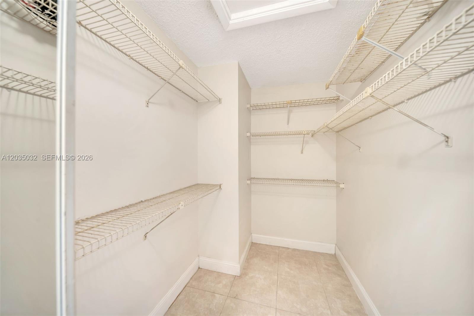 5223 Gate Lake Road, Unit 5223 Tamarac, FL 33319 - Photo 24 of 37 a view of an empty walk in closet