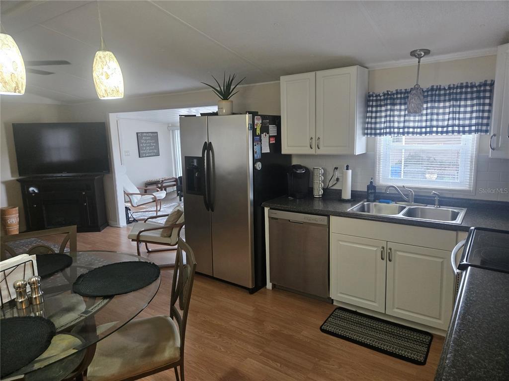 1710 7th Street Southwest, Unit 93 Ruskin, FL 33570 - Photo 12 of 38 a kitchen with sink refrigerator and window