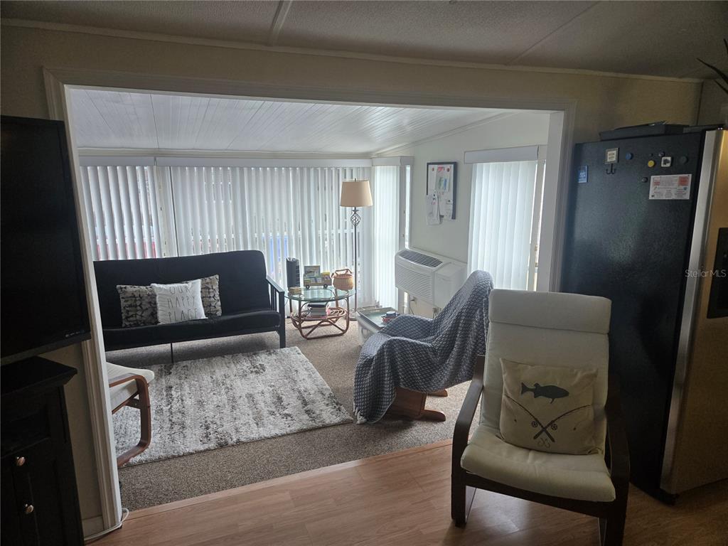 1710 7th Street Southwest, Unit 93 Ruskin, FL 33570 - Photo 18 of 38 a living room with furniture and a flat screen tv