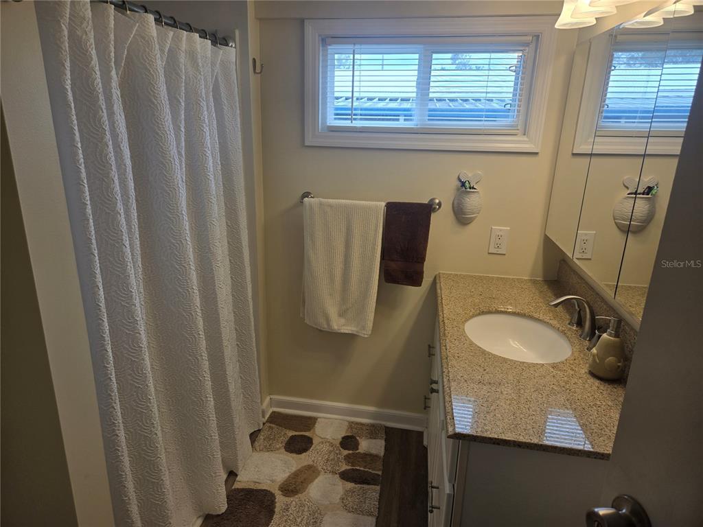 1710 7th Street Southwest, Unit 93 Ruskin, FL 33570 - Photo 28 of 38 a bathroom with a sink a toilet and shower curtain