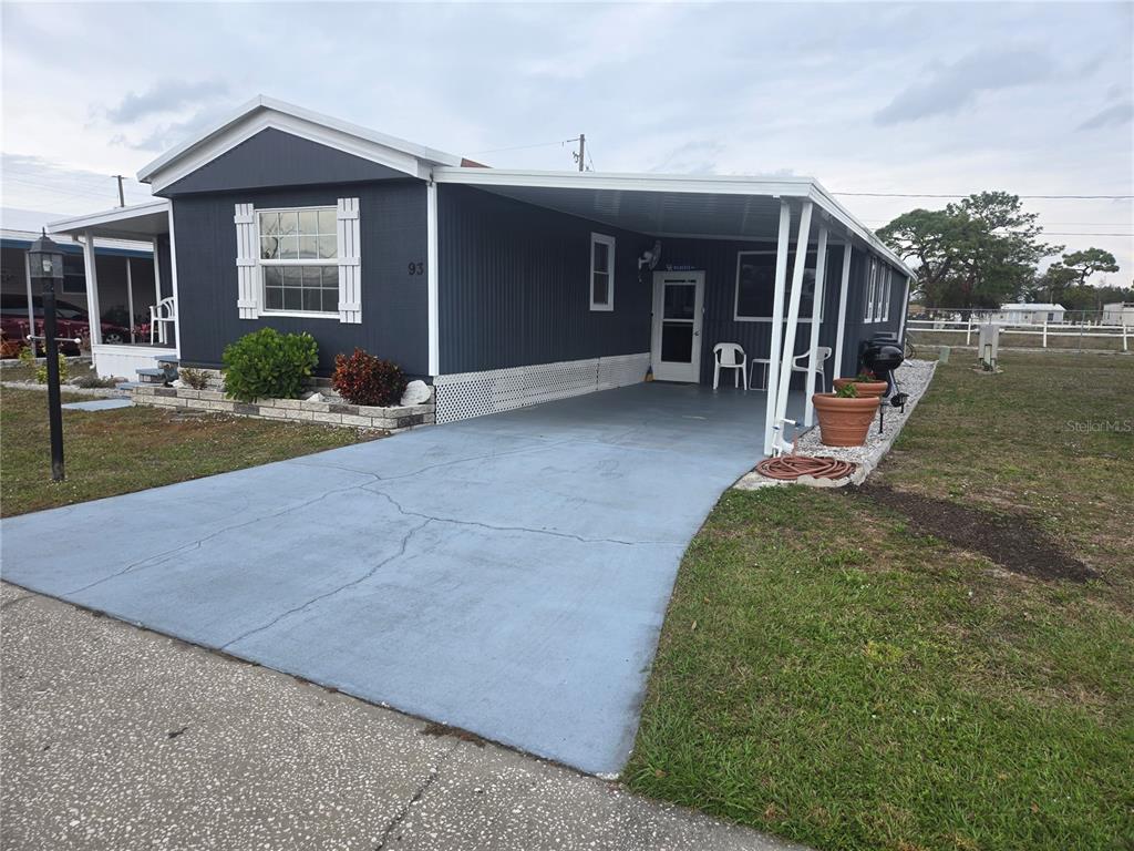 1710 7th Street Southwest, Unit 93 Ruskin, FL 33570 - Photo 3 of 38 a view of a house with backyard and porch